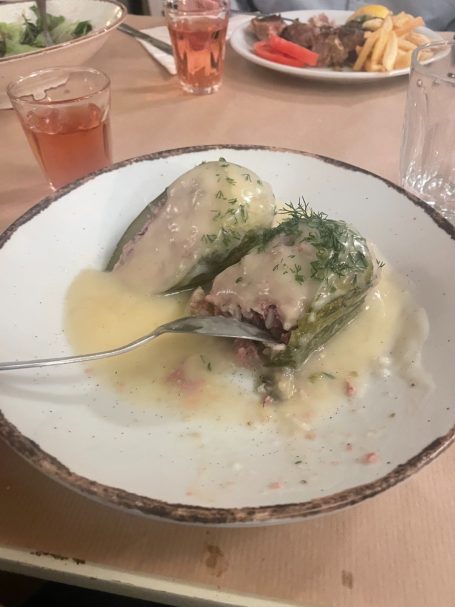 cabbage rolls covered in dill and a sauce