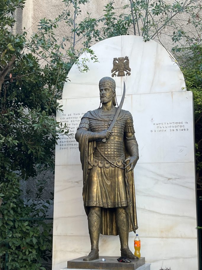 Constantine statue with a fanta blottle behind him